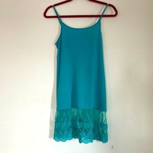 Turquoise tank with lace detail.